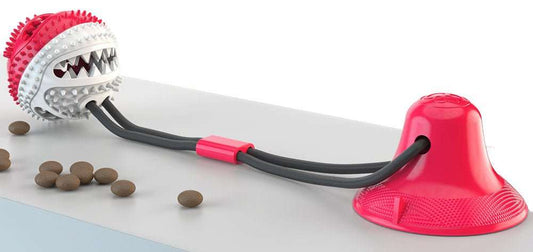Ball-shaped suction cup dog treat dispenser toy with ridges and dual-rope strings for interactive play and dental care.