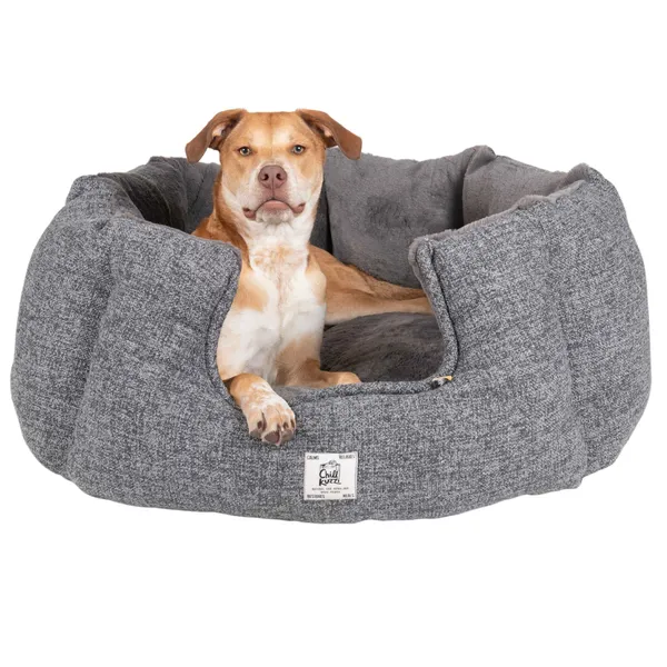 Dog resting comfortably in a gray Chill Kuzzi Round Bed with FIR technology for relaxation and joint support
