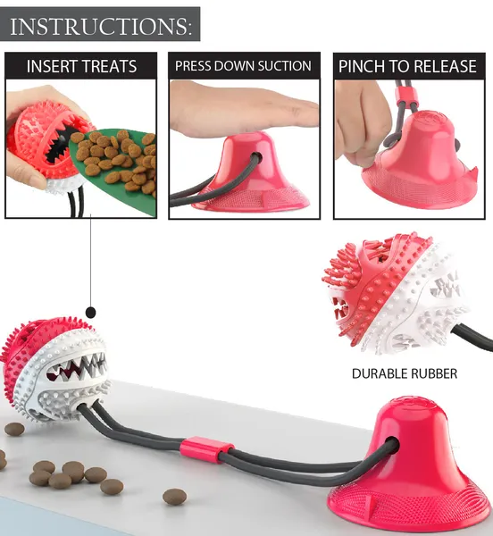 Ball-shaped suction cup dog treat dispenser toy with dual ropes and treat pockets mounted on a tile floor