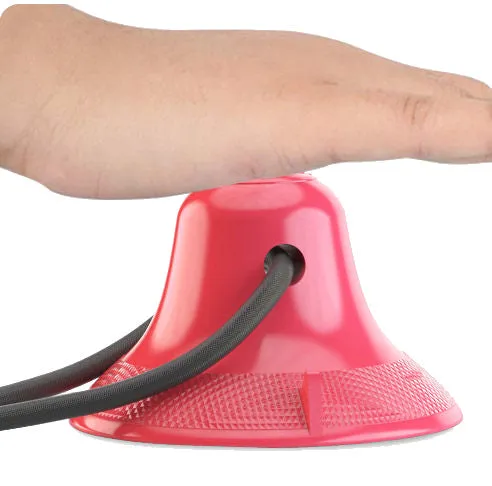 Ball-shaped suction cup dog treat dispenser toy with dual ropes and ridged surface for dental care and interactive play attached to a tile floor